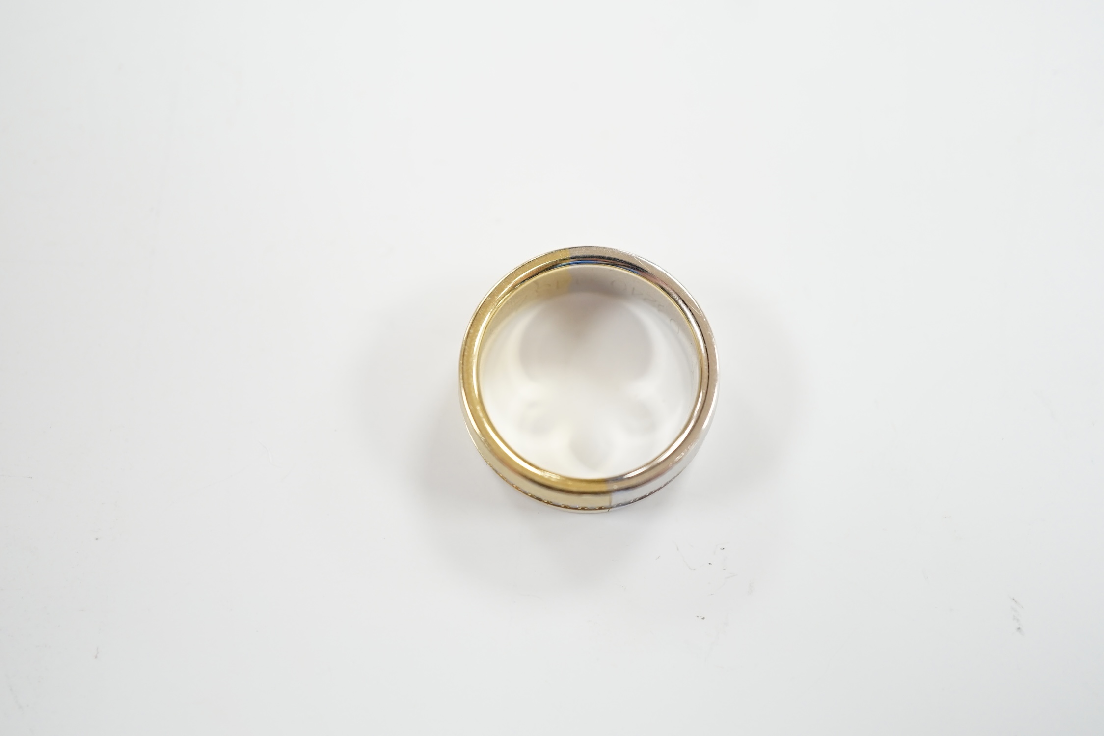 A two colour base metal band, with central row of simulated diamonds, size O.